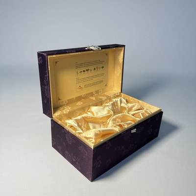 L'emballage cosmétique de luxe pourpre enferme dans une boîte la boîte faciale d'emballage de crème